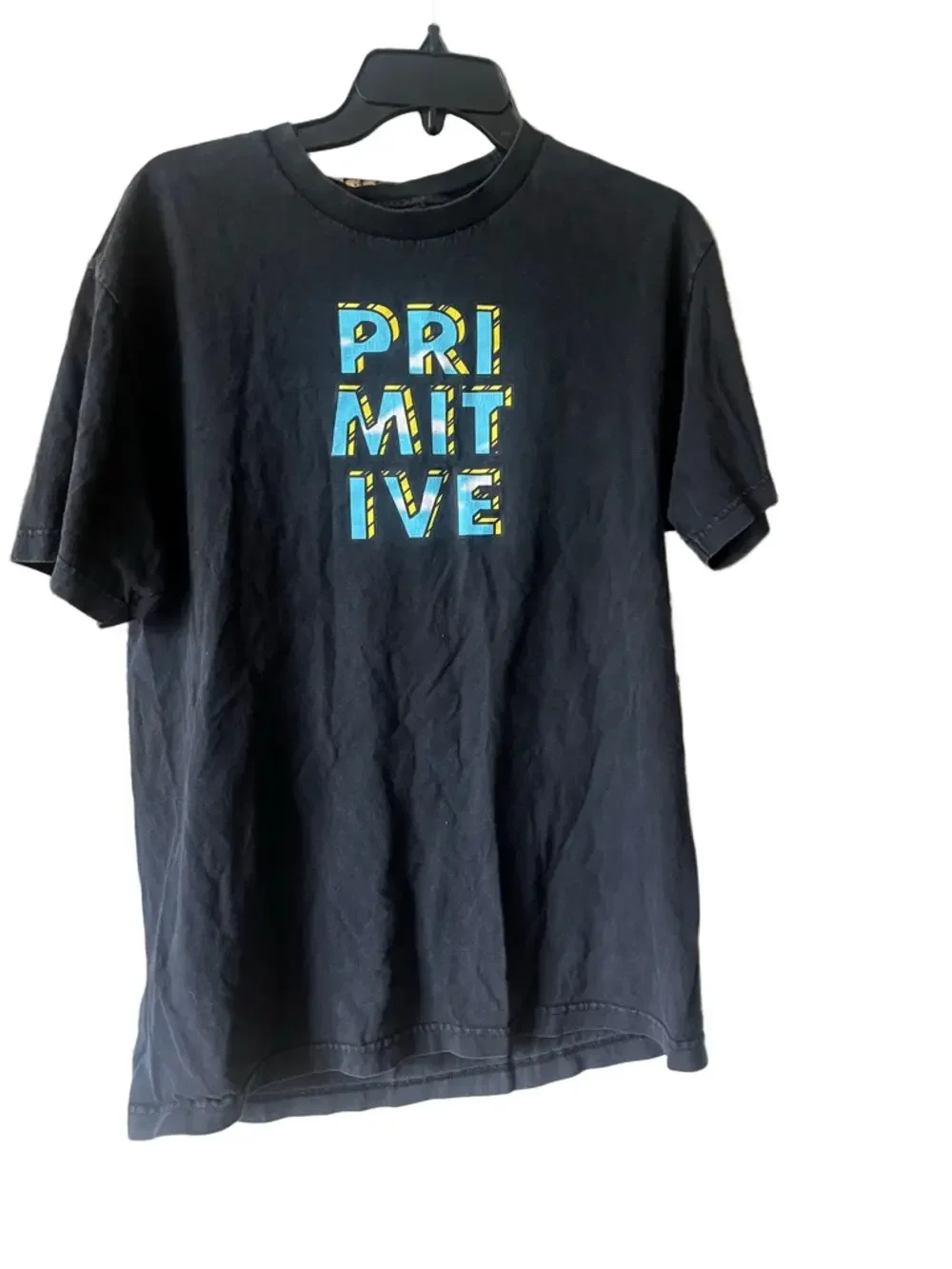 Primitive Black Tee with Blue and Yellow Block Logo